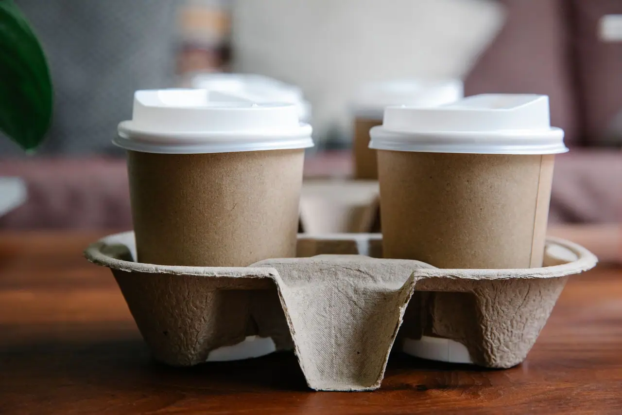 Two kraft paper coffee cups in a cup carrier