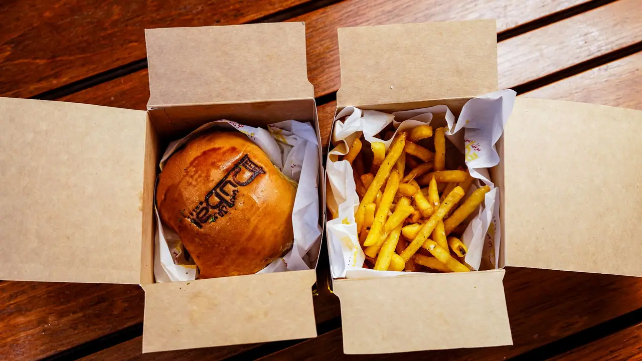 Burger and fries in kraft takeaway boxes